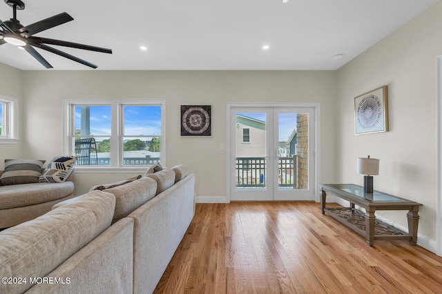 living room featuring light hardwood / wood-style flooring and ceiling fan