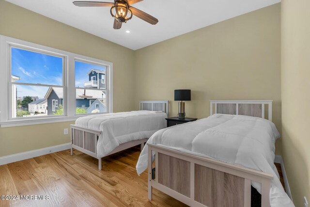 bedroom with light hardwood / wood-style flooring and ceiling fan