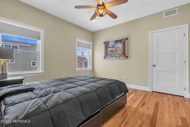 bedroom with light hardwood / wood-style flooring and ceiling fan