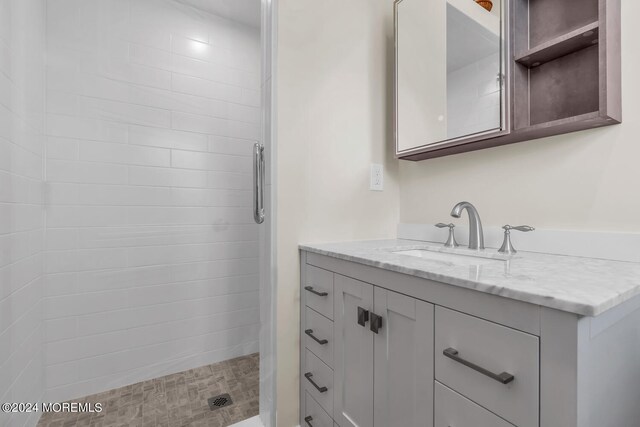 bathroom featuring vanity and a tile shower