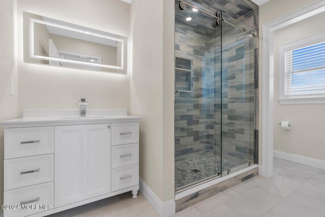 bathroom featuring vanity, walk in shower, and tile patterned floors