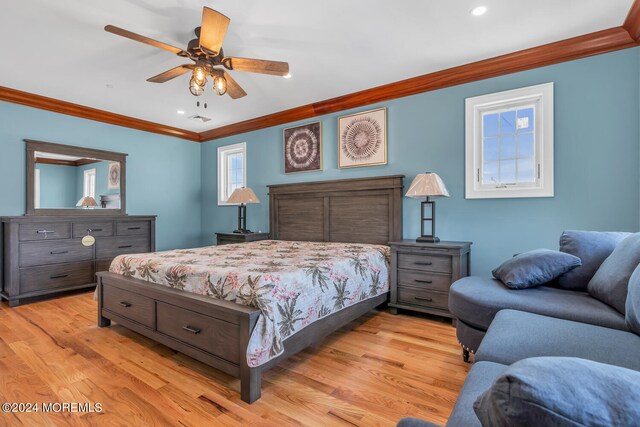 bedroom featuring ceiling fan, light hardwood / wood-style flooring, and ornamental molding