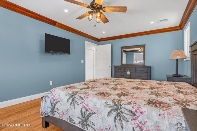 bedroom featuring ceiling fan, crown molding, and hardwood / wood-style flooring