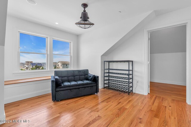 sitting room with light hardwood / wood-style flooring and vaulted ceiling