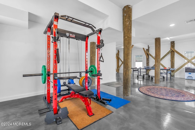 workout room featuring concrete floors