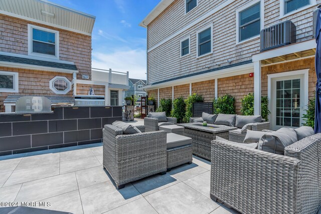 view of patio / terrace with a balcony and outdoor lounge area