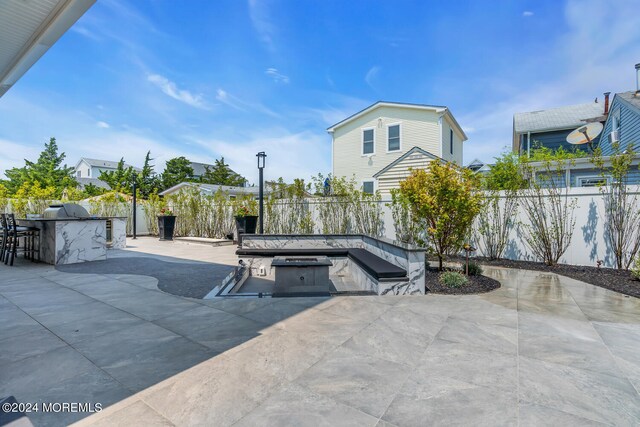 view of patio / terrace featuring an outdoor fire pit