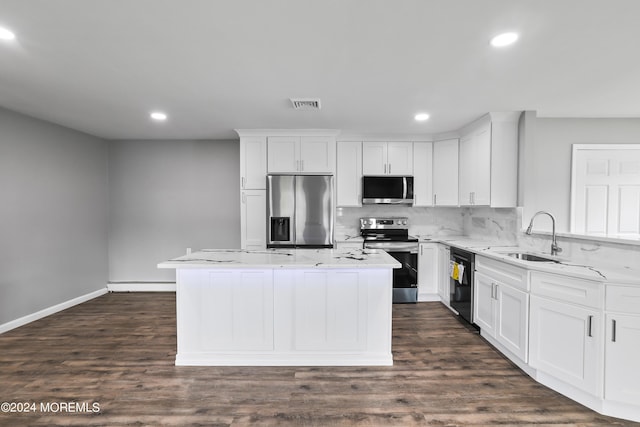 kitchen featuring baseboard heating, white cabinetry, appliances with stainless steel finishes, and a kitchen island