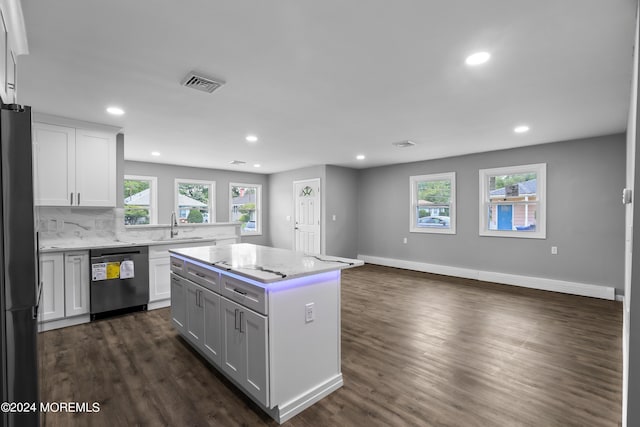 kitchen featuring white cabinets, dishwasher, a center island, sink, and refrigerator