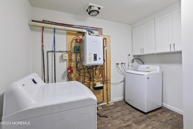 laundry room featuring cabinets, washing machine and dryer, dark hardwood / wood-style flooring, and water heater