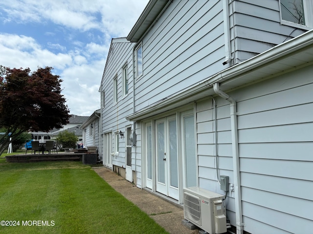 view of side of home with a lawn