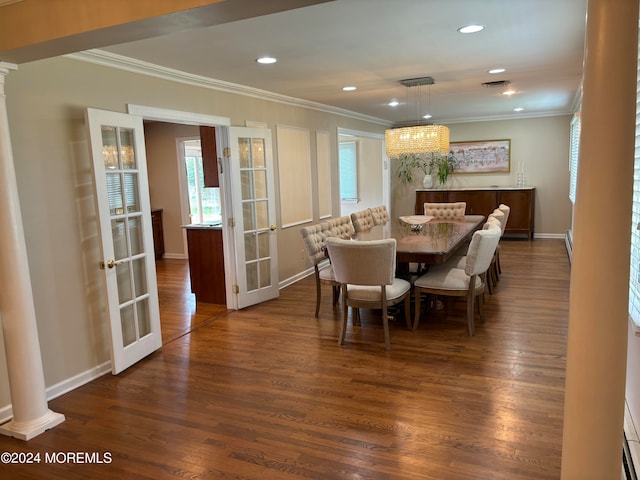 dining space with ornate columns, dark hardwood / wood-style floors, ornamental molding, and french doors