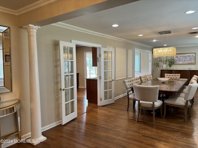 dining space featuring crown molding, decorative columns, french doors, and dark hardwood / wood-style flooring