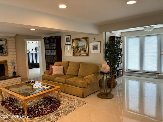 tiled living room featuring brick wall and a brick fireplace