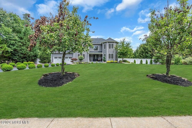 view of front of property with a garage and a front yard