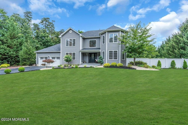 view of front of home featuring a garage and a front lawn