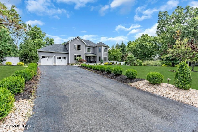 view of front property with a garage and a front lawn