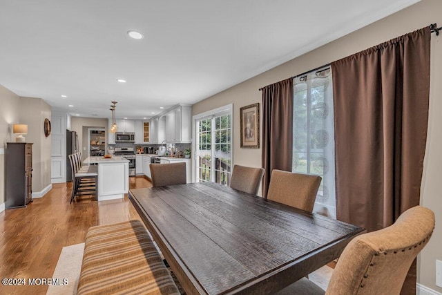 dining space with light wood-type flooring