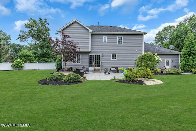 rear view of property featuring a patio area and a lawn