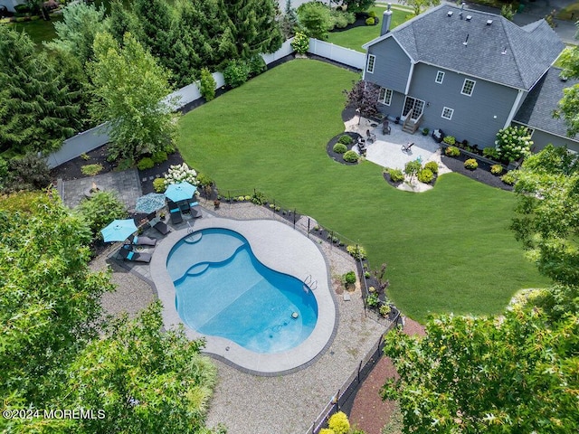 view of swimming pool with a patio area and a lawn