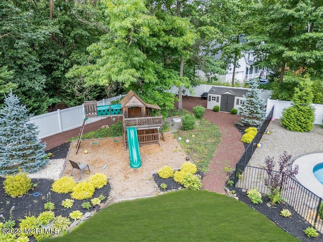 view of playground with a shed