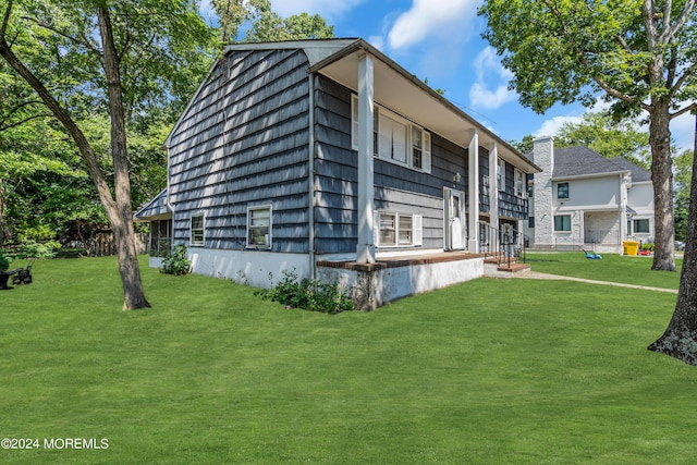 view of property exterior with a yard