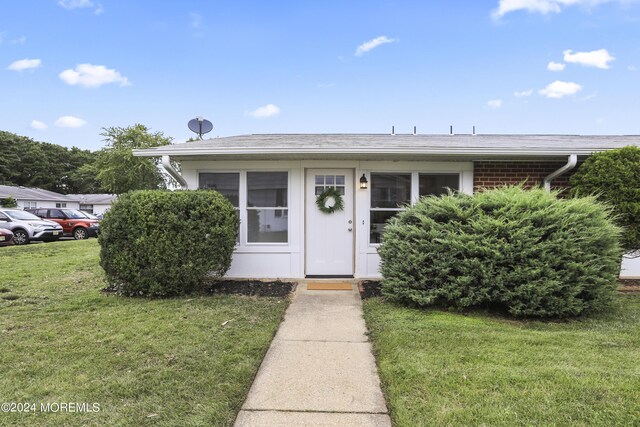 bungalow-style house featuring a front yard