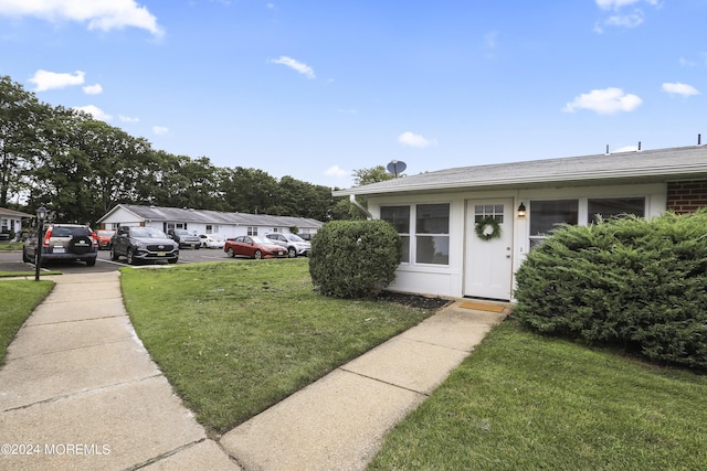 entrance to property featuring a lawn