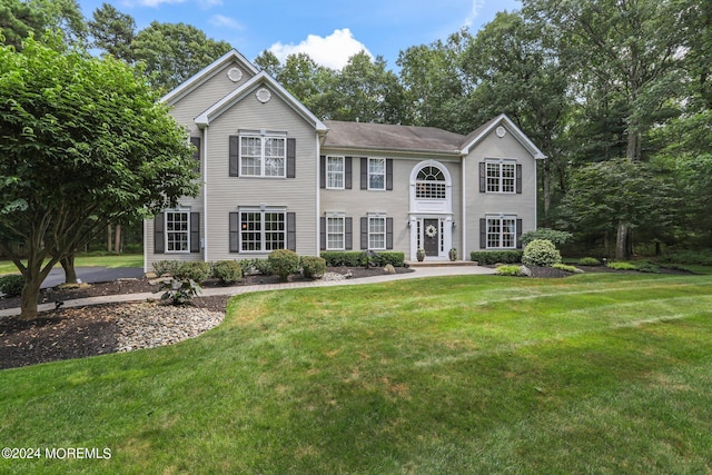 colonial home with a front yard