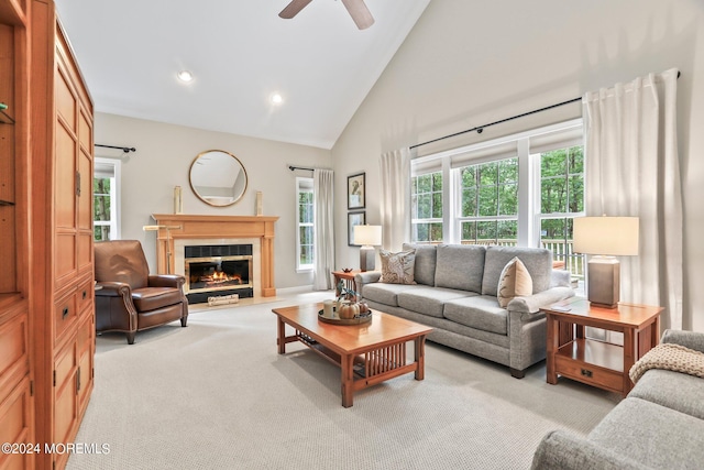 living room with recessed lighting, light colored carpet, a glass covered fireplace, ceiling fan, and high vaulted ceiling