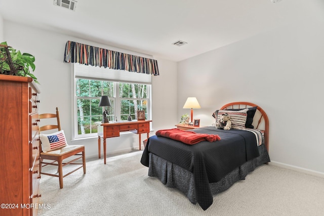 carpeted bedroom featuring visible vents and baseboards