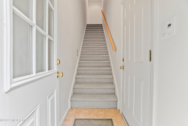 staircase with tile patterned floors