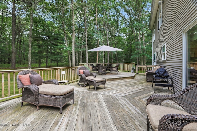 wooden terrace with outdoor dining area