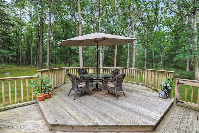 wooden terrace with outdoor dining area