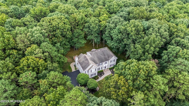 birds eye view of property featuring a wooded view