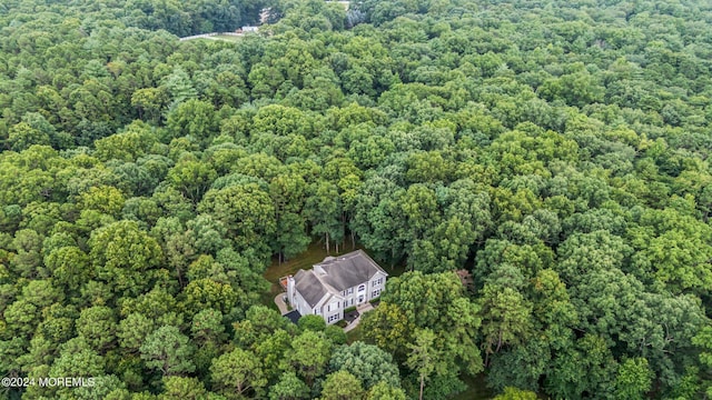 birds eye view of property featuring a view of trees