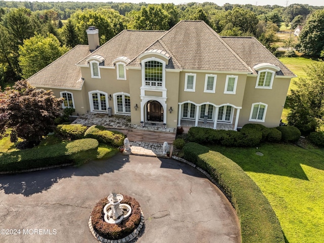 french country home featuring a front lawn