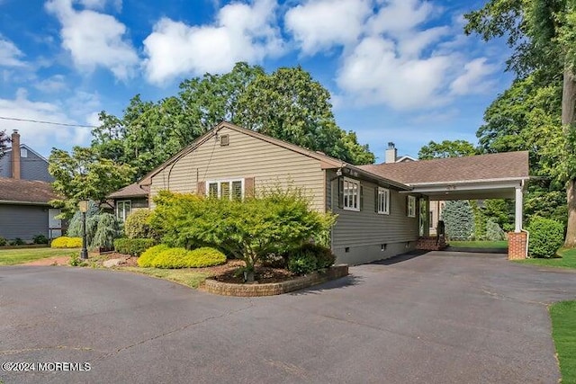 view of home's exterior featuring a carport