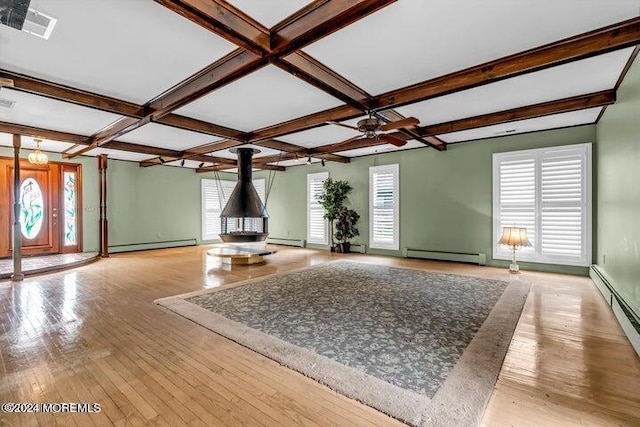 unfurnished living room with beam ceiling, light hardwood / wood-style floors, and baseboard heating