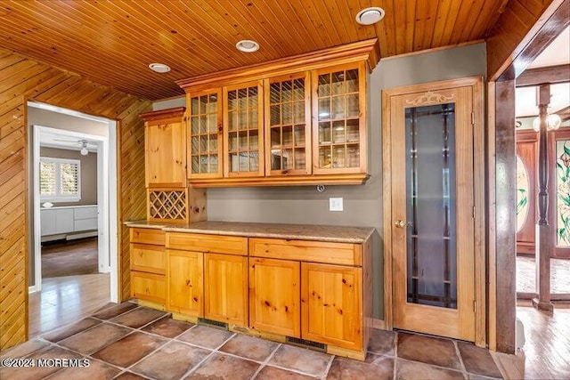 kitchen featuring wood ceiling and wood walls