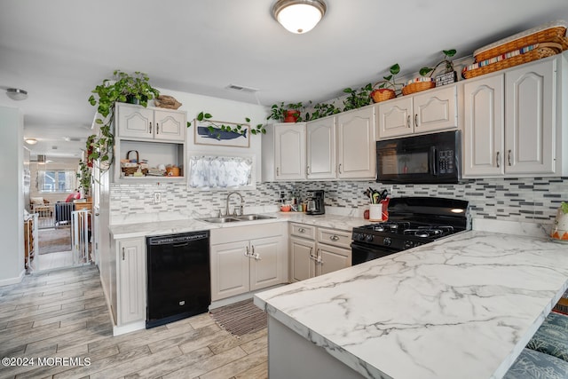 kitchen featuring open shelves, backsplash, white cabinets, a sink, and black appliances