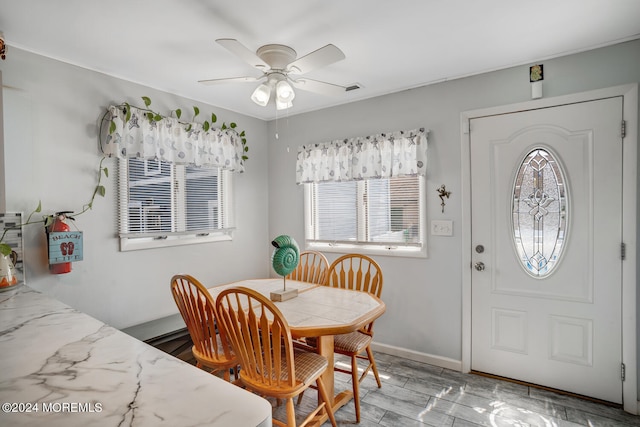 dining room featuring ceiling fan and baseboards