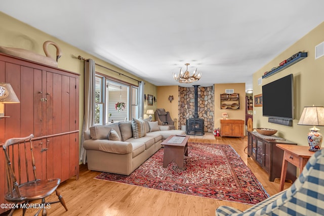 living room featuring a wood stove and light wood-type flooring