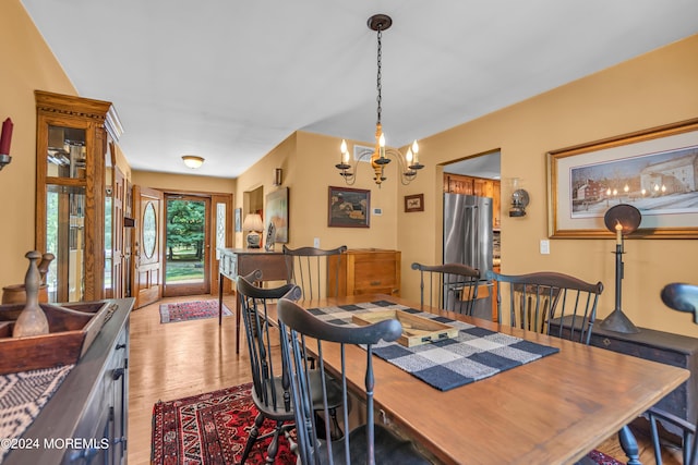 dining room with an inviting chandelier and light wood-type flooring