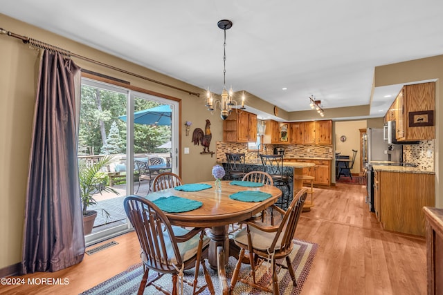 dining space featuring a chandelier and light hardwood / wood-style floors