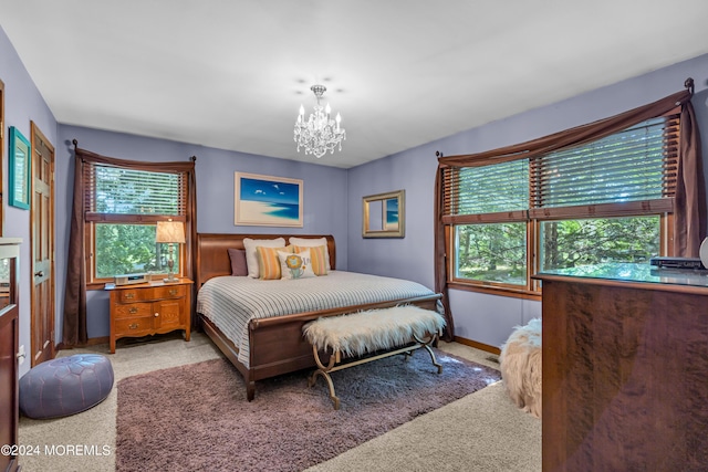 carpeted bedroom with an inviting chandelier