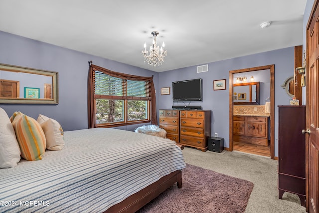 bedroom with connected bathroom, light carpet, and a notable chandelier