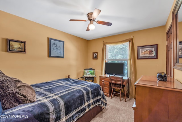 bedroom featuring ceiling fan and light carpet