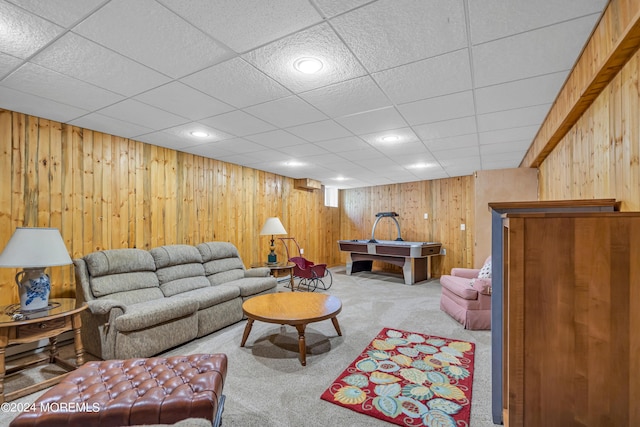 carpeted living room with wood walls