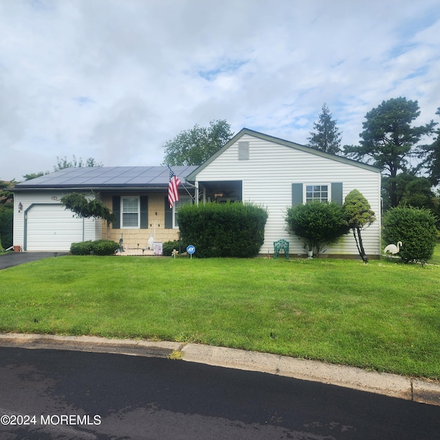 ranch-style home with a garage and a front yard